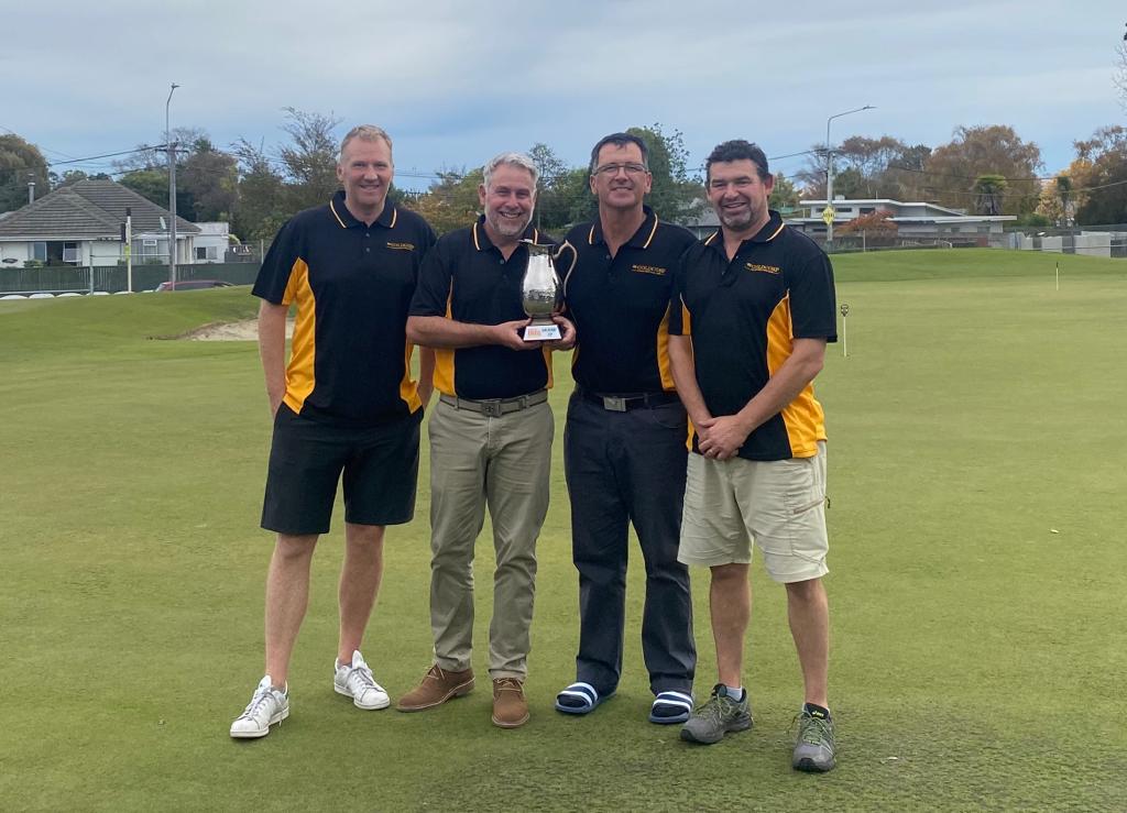 Gold Corp crew with trophy in black and gold shirts